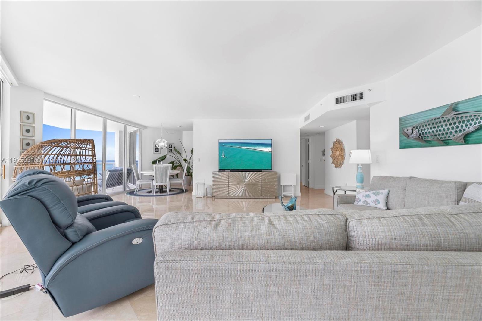 18671 Collins Avenue, Unit 1902 Sunny Isles Beach, FL 33160 - Photo 7 of 53 a living room with furniture and a couch