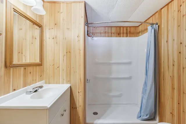 a bathroom with a shower and a sink