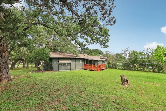 a view of a house with a yard and sitting area