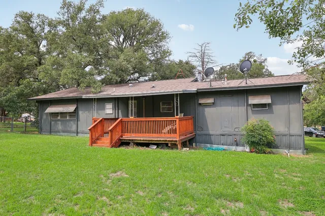 a front view of a house with a yard table and chairs