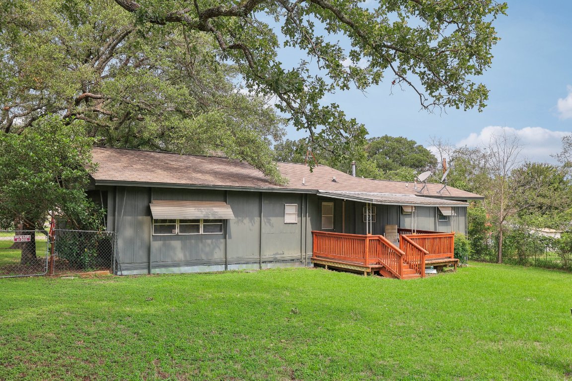 201 Bronco Drive Burnet, TX 78611 - Photo 25 of 30 a backyard of a house with table and chairs plants and large tree