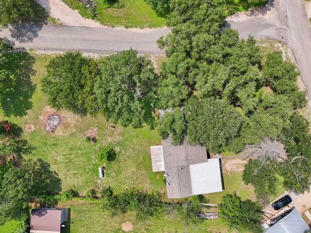 an aerial view of a house with a yard and garden