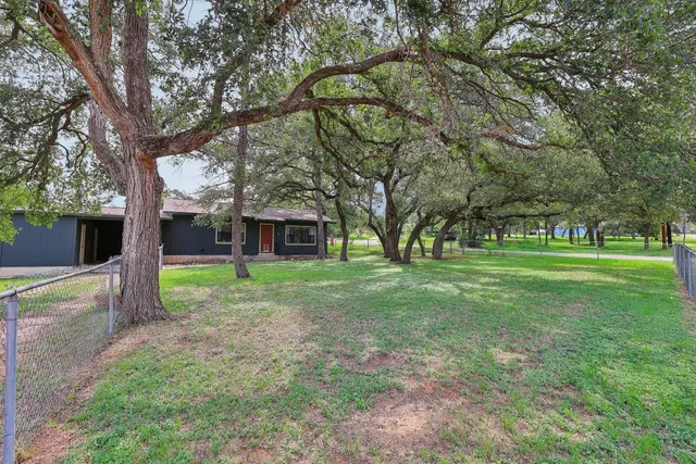 a view of a house with a backyard