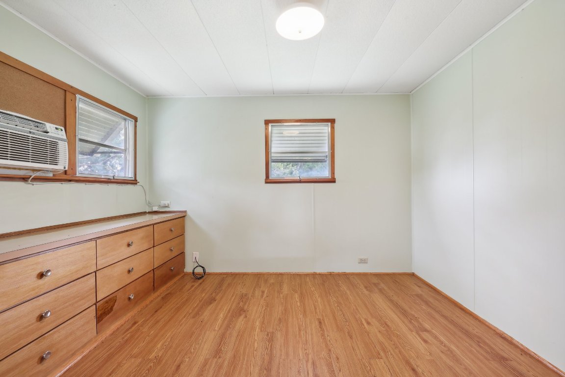 201 Bronco Drive Burnet, TX 78611 - Photo 8 of 30 wooden floor in an empty room with a window