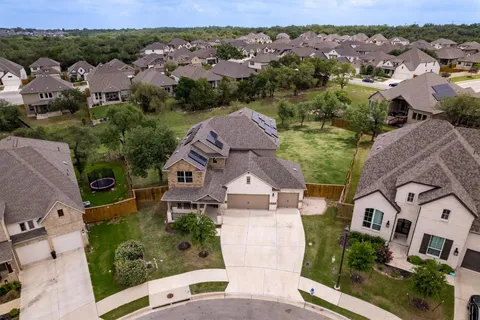 an aerial view of multiple houses with a yard