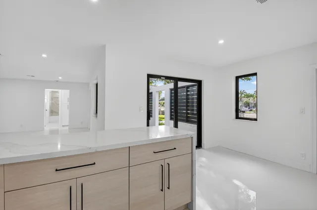 a bathroom with double vanity sink and a window