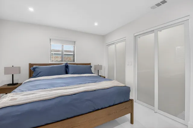 a living room with furniture a rug and white walls