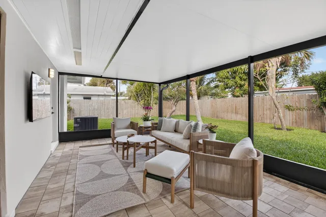 a view of a house with a yard and a tree