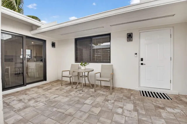 a kitchen with white cabinets stainless steel appliances and sink
