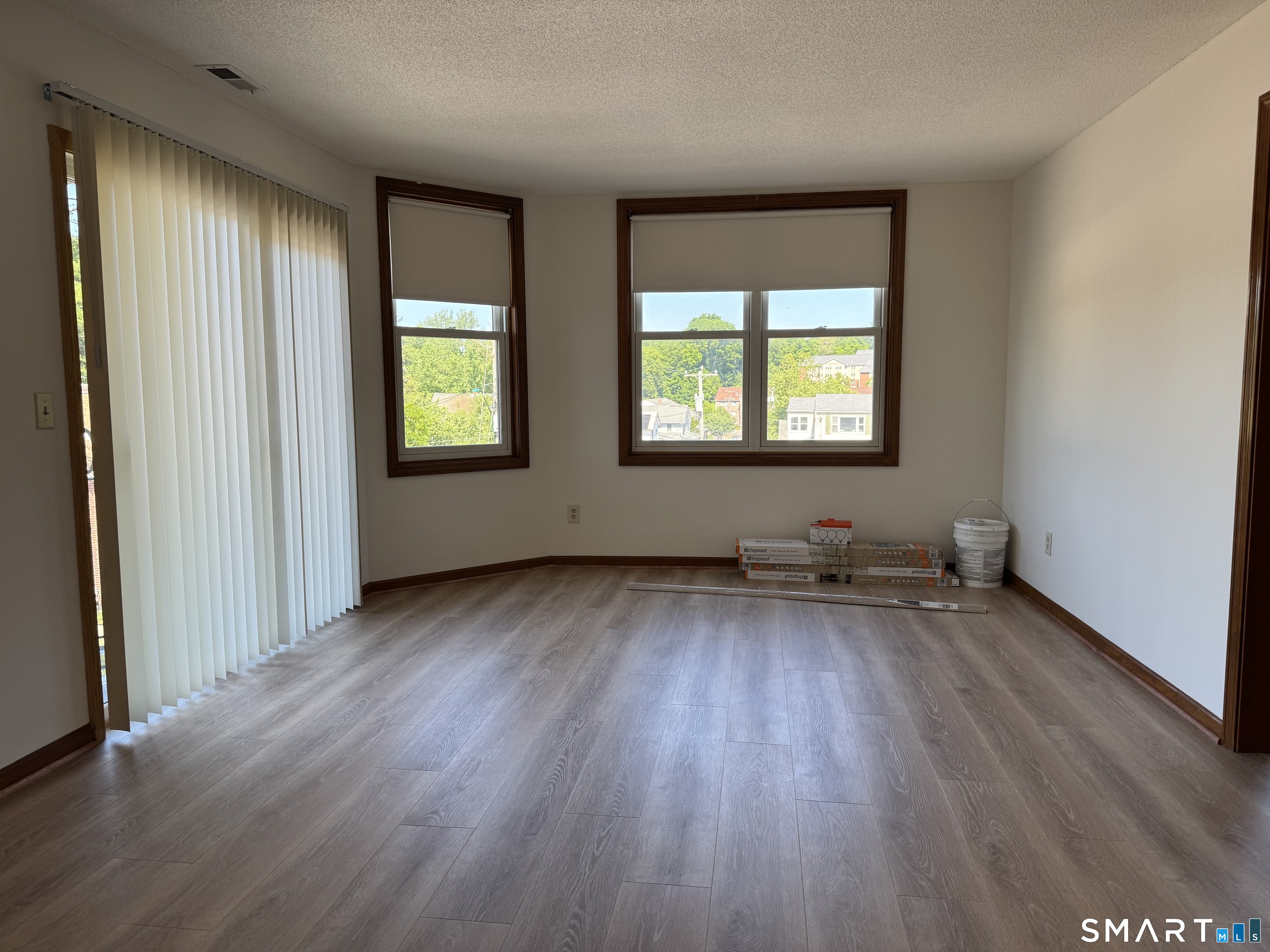 1022 Main Street, Unit 7 Branford, CT 06405 - Photo 8 of 10 an empty room with wooden floor and windows