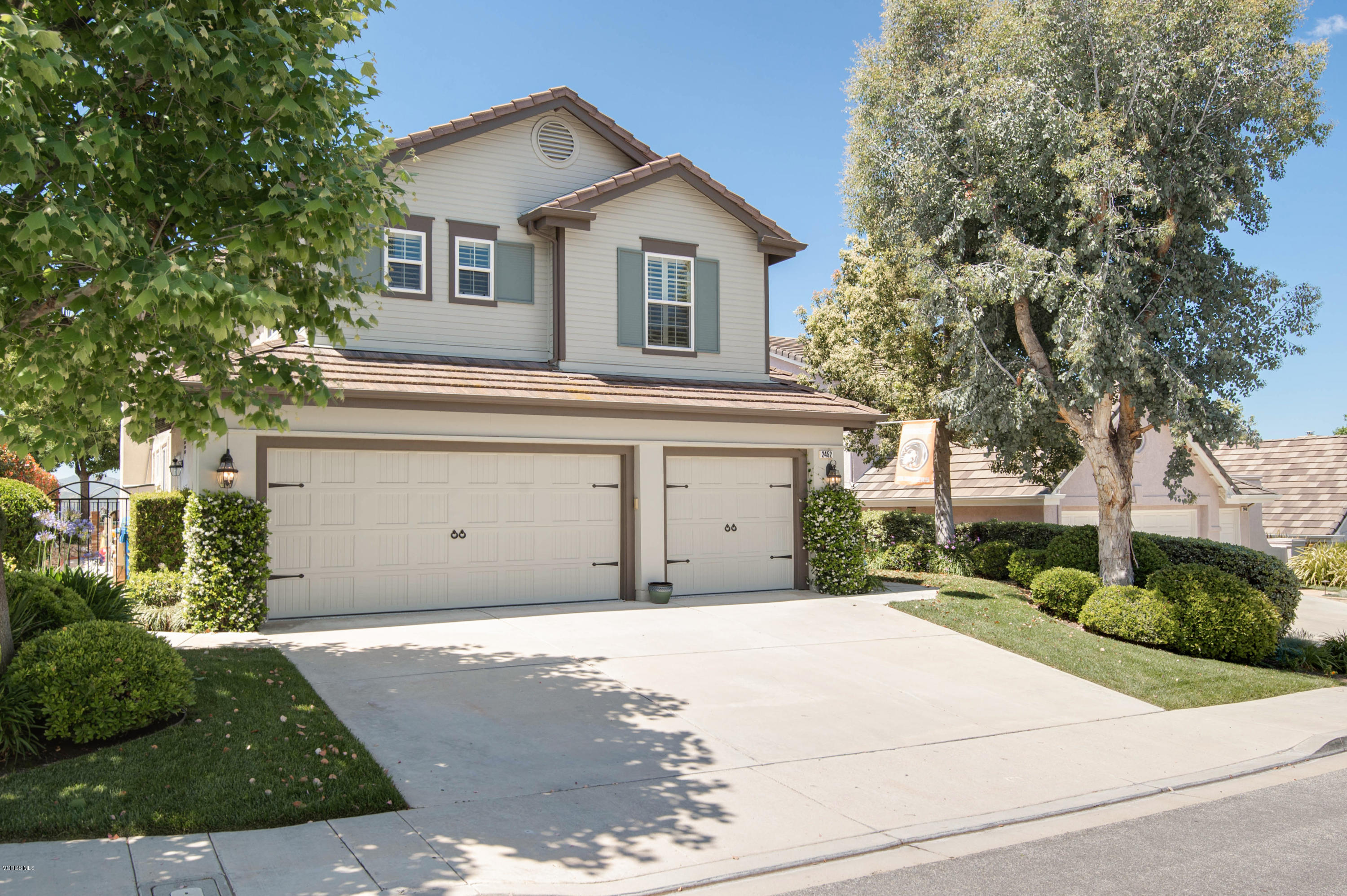 2452 Gillingham Circle Thousand Oaks, CA 91362 - Photo 2 of 43 a front view of a house with a yard and garage