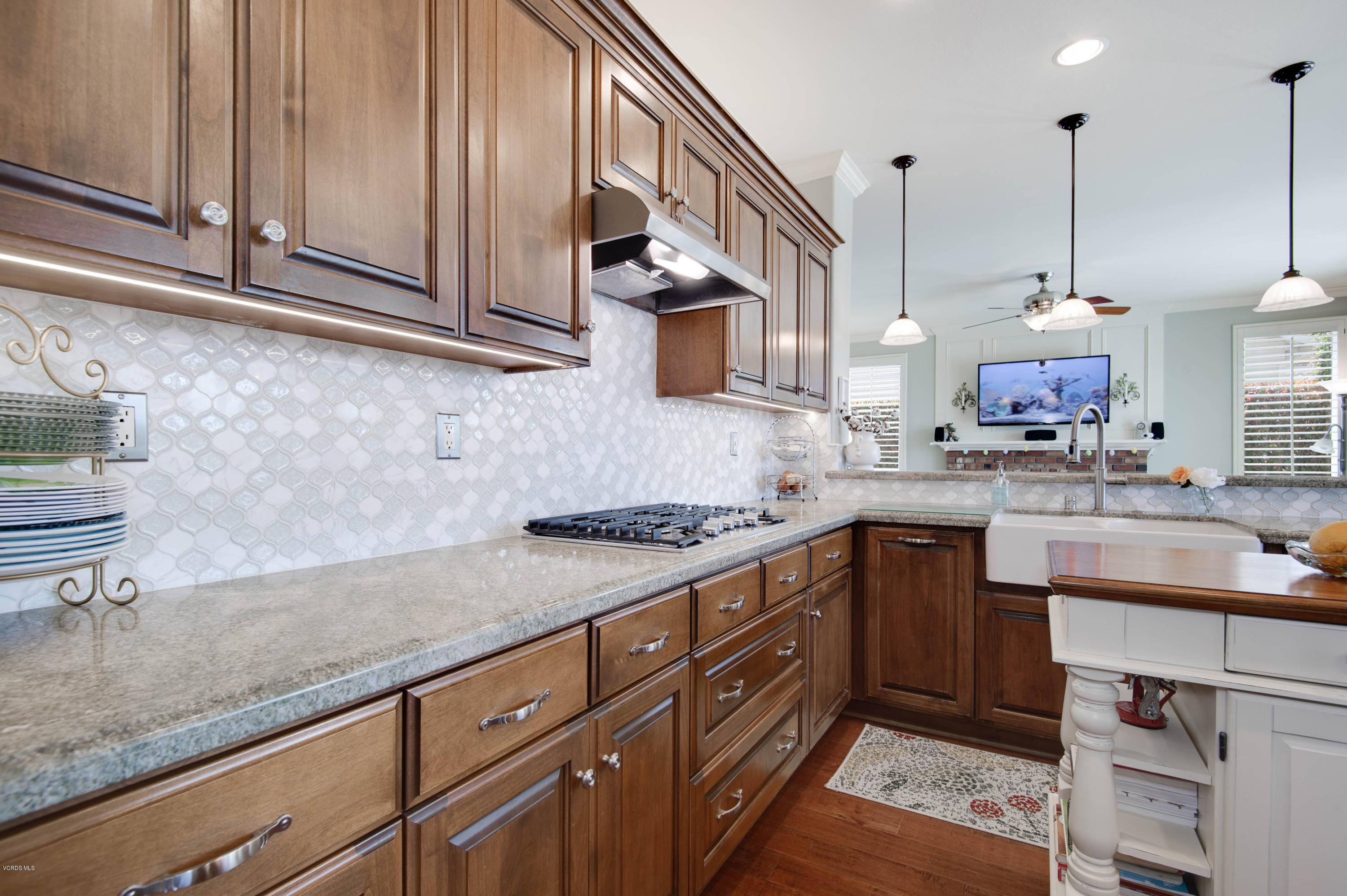 2452 Gillingham Circle Thousand Oaks, CA 91362 - Photo 12 of 43 a kitchen with stainless steel appliances granite countertop a sink a stove and a wooden cabinets