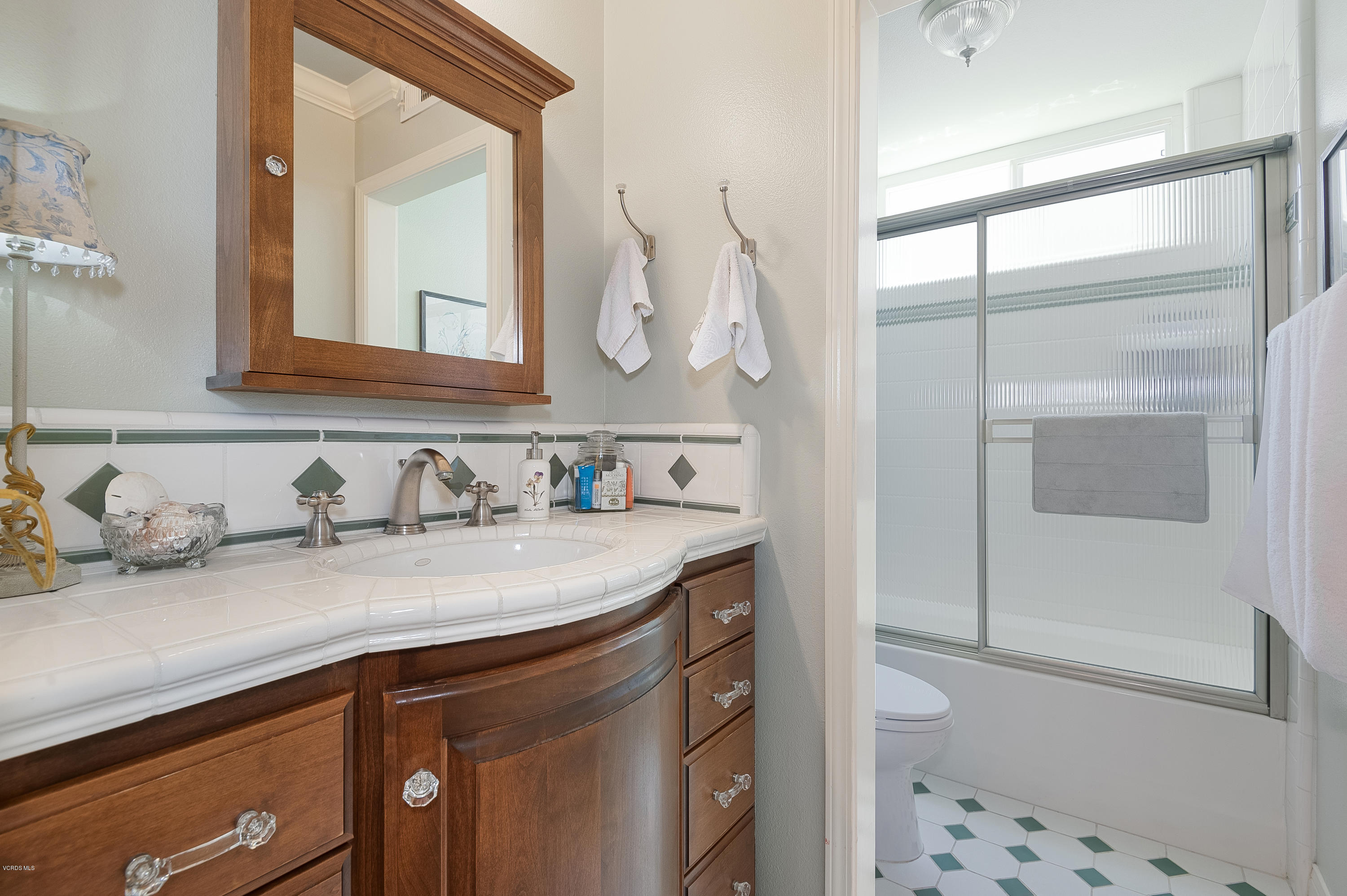 2452 Gillingham Circle Thousand Oaks, CA 91362 - Photo 34 of 43 a bathroom with a granite countertop sink vanity mirror and shower