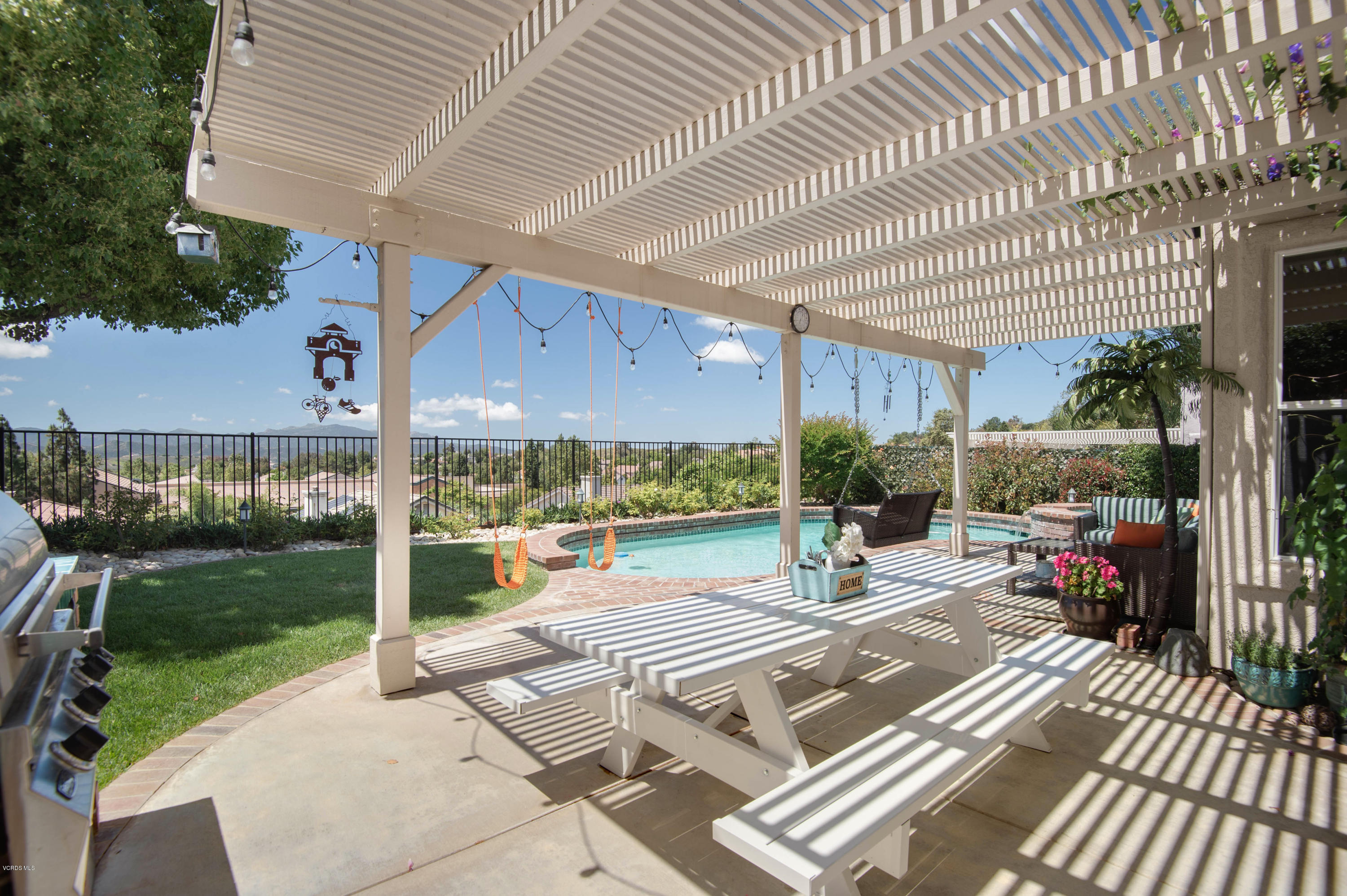 2452 Gillingham Circle Thousand Oaks, CA 91362 - Photo 39 of 43 a view of a patio with table and chairs potted plants with wooden floor and fence