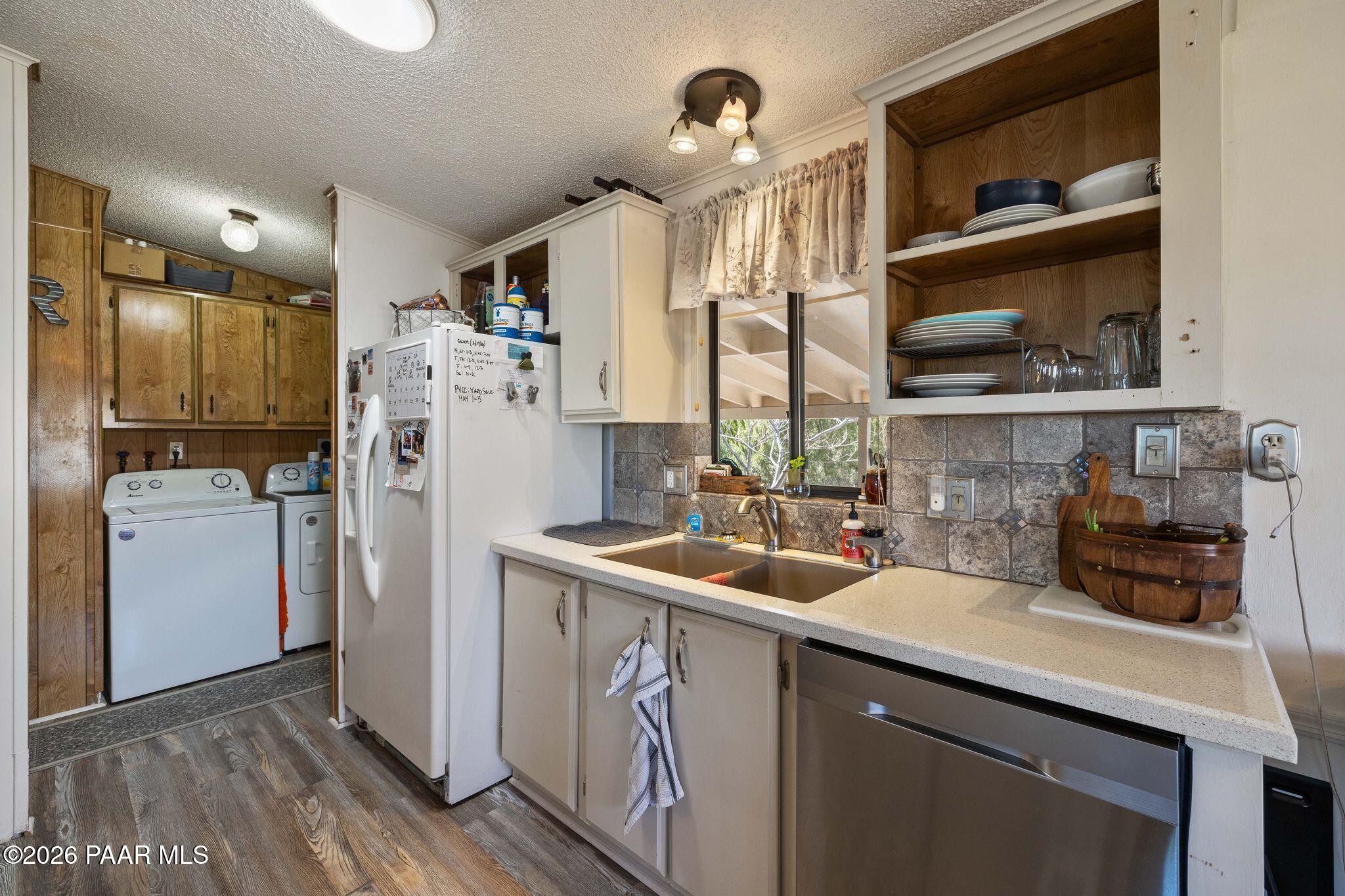 10194 East Durham Road Dewey, AZ 86327 - Photo 17 of 47 a kitchen with sink a refrigerator and cabinets