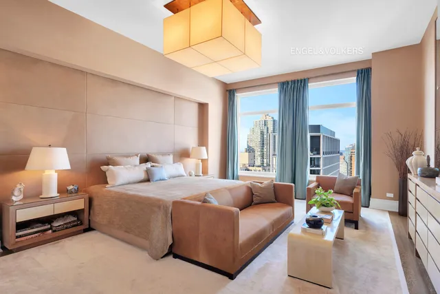 a living room with furniture and a large mirror