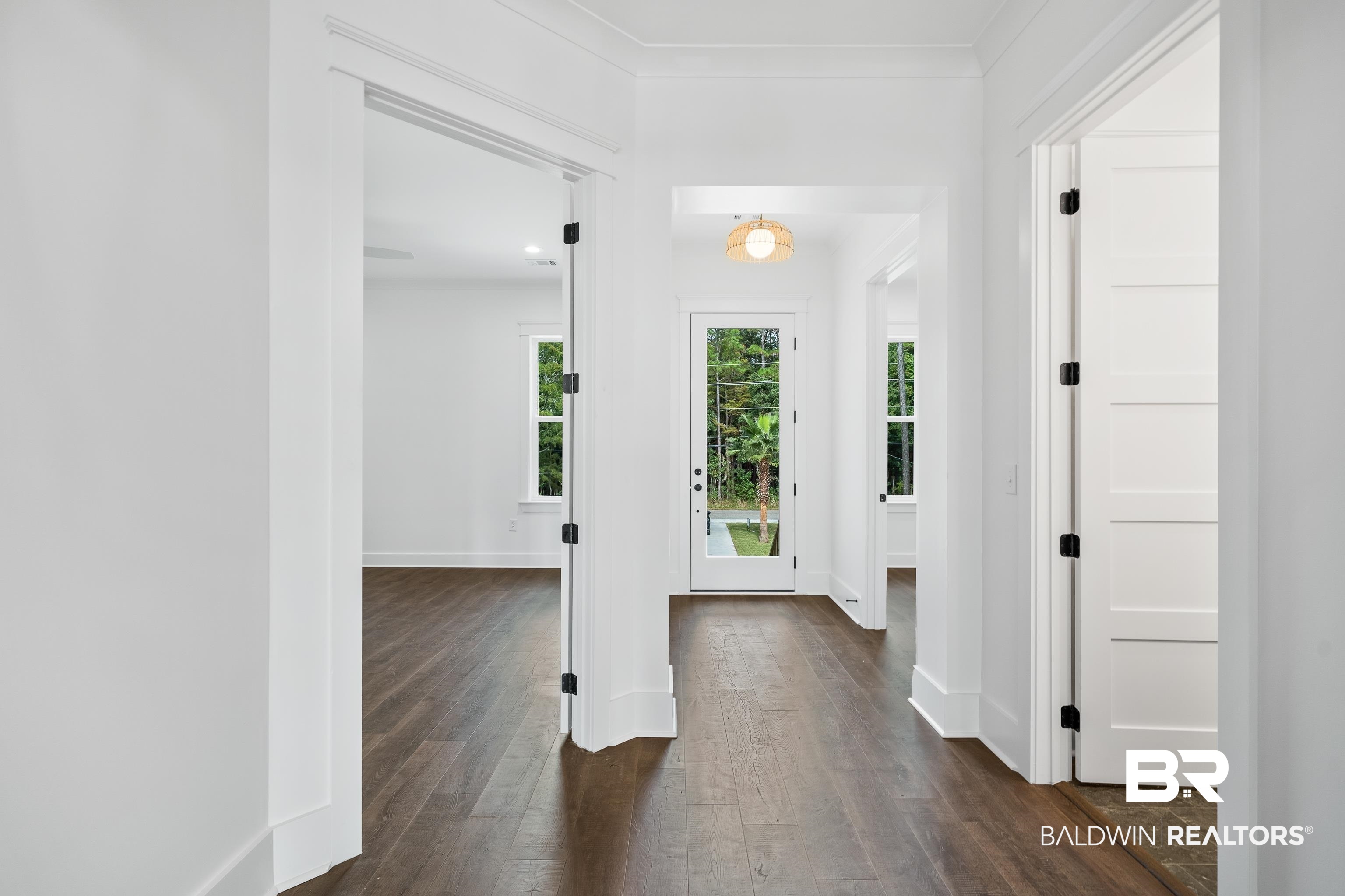 12453 County Road 1 Fairhope, AL 36532 - Photo 3 of 33 Entryway with dark hardwood / wood-style flooring and crown molding