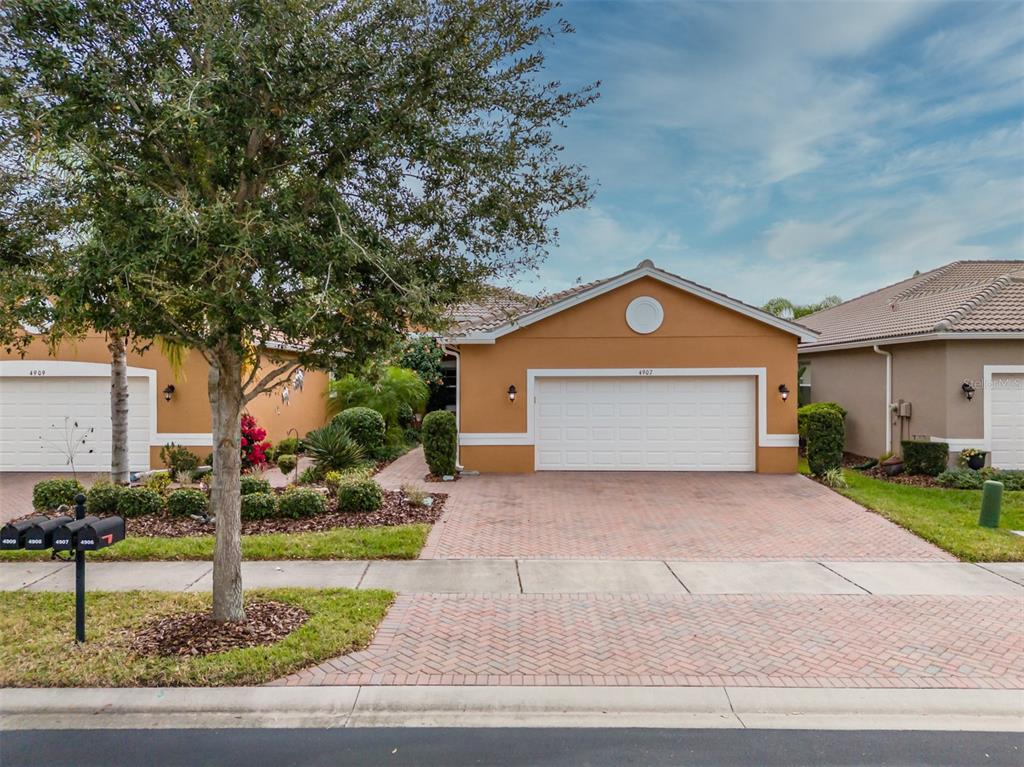 4907 River Falls Way Wimauma, FL 33598 - Photo 1 of 1 a front view of a house with a yard and garage