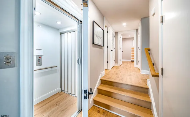 a view of an entryway with wooden floor and a livingroom view