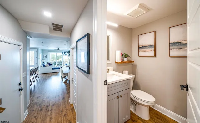 a bathroom with a sink a toilet and a large mirror