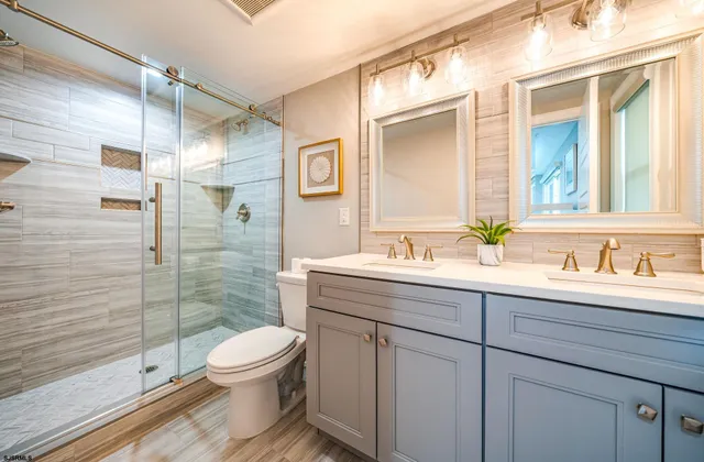 a bathroom with a double vanity sink toilet and shower