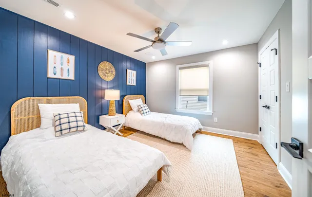 a bedroom with two beds and a window