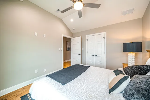 a bedroom with a large bed and a chandelier