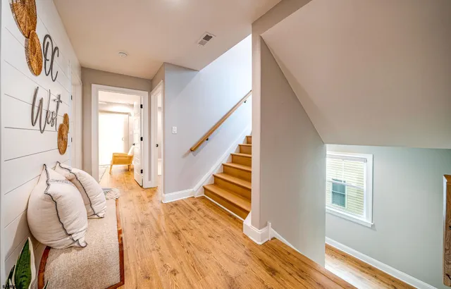 a view of entryway and hall with wooden floor