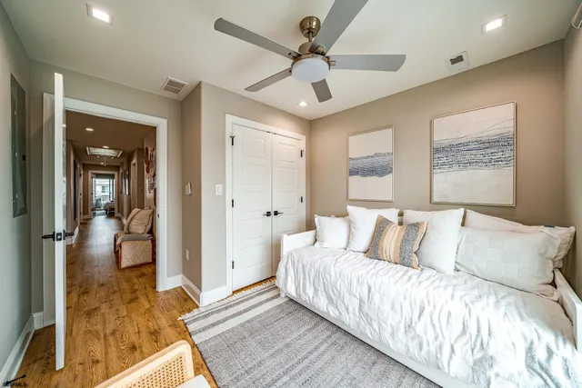 a spacious bedroom with a bed and a large window