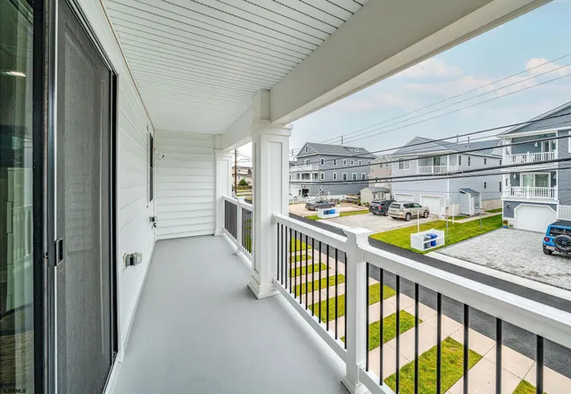 a view of a balcony and car parked