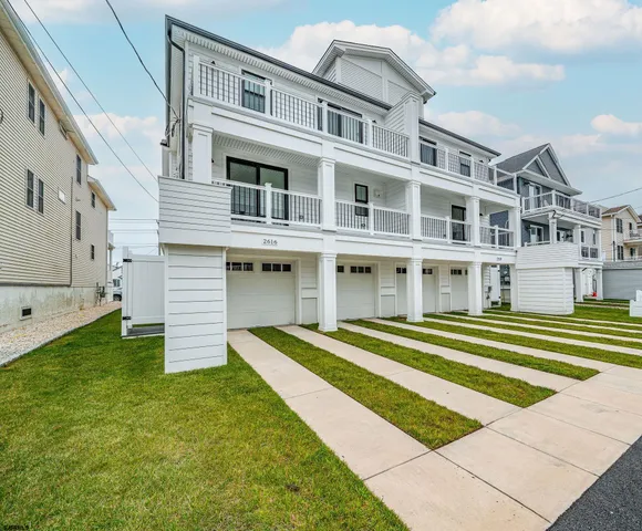 a front view of a house with a yard table and chairs