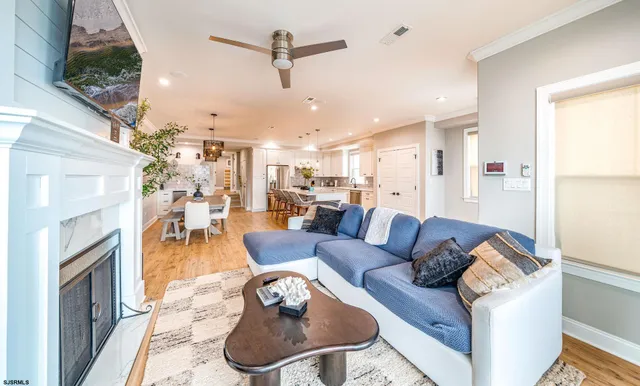 a living room with furniture kitchen view and a fireplace