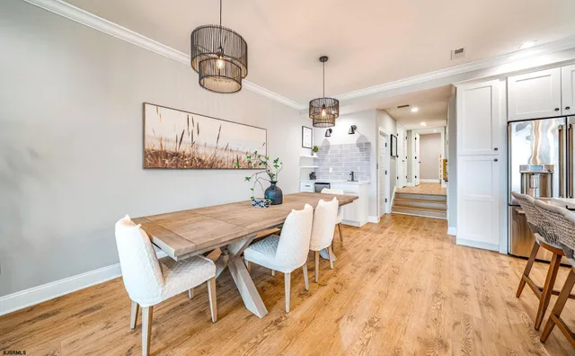 a view of a dining room with furniture wooden floor and a chandelier
