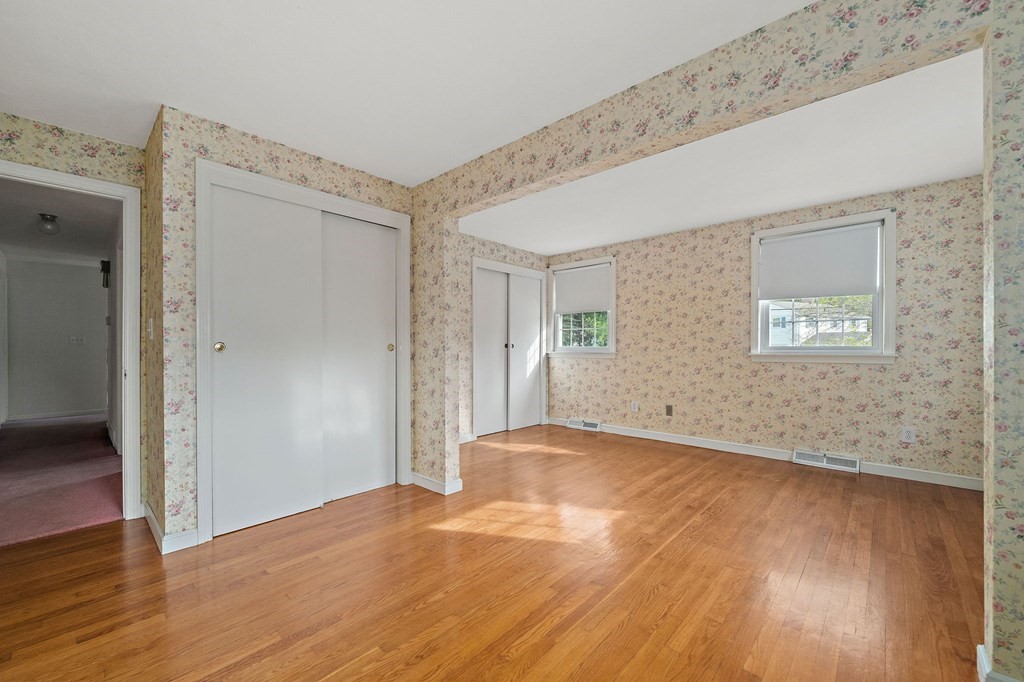 11 Old Coach Road Canton, MA 02021 - Photo 16 of 33 a view of an empty room with wooden floor and a window