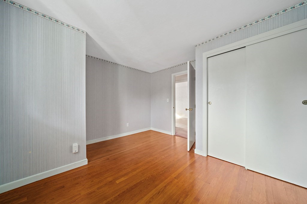 11 Old Coach Road Canton, MA 02021 - Photo 19 of 33 a view of an empty room with wooden floor