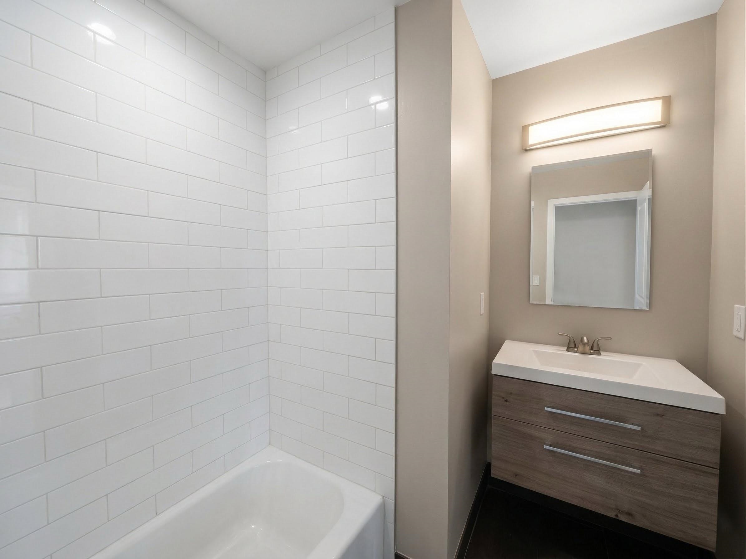 420 6th Street, Unit 3 Union City, NJ 07087 - Photo 11 of 12 a bathroom with a sink and a bathtub