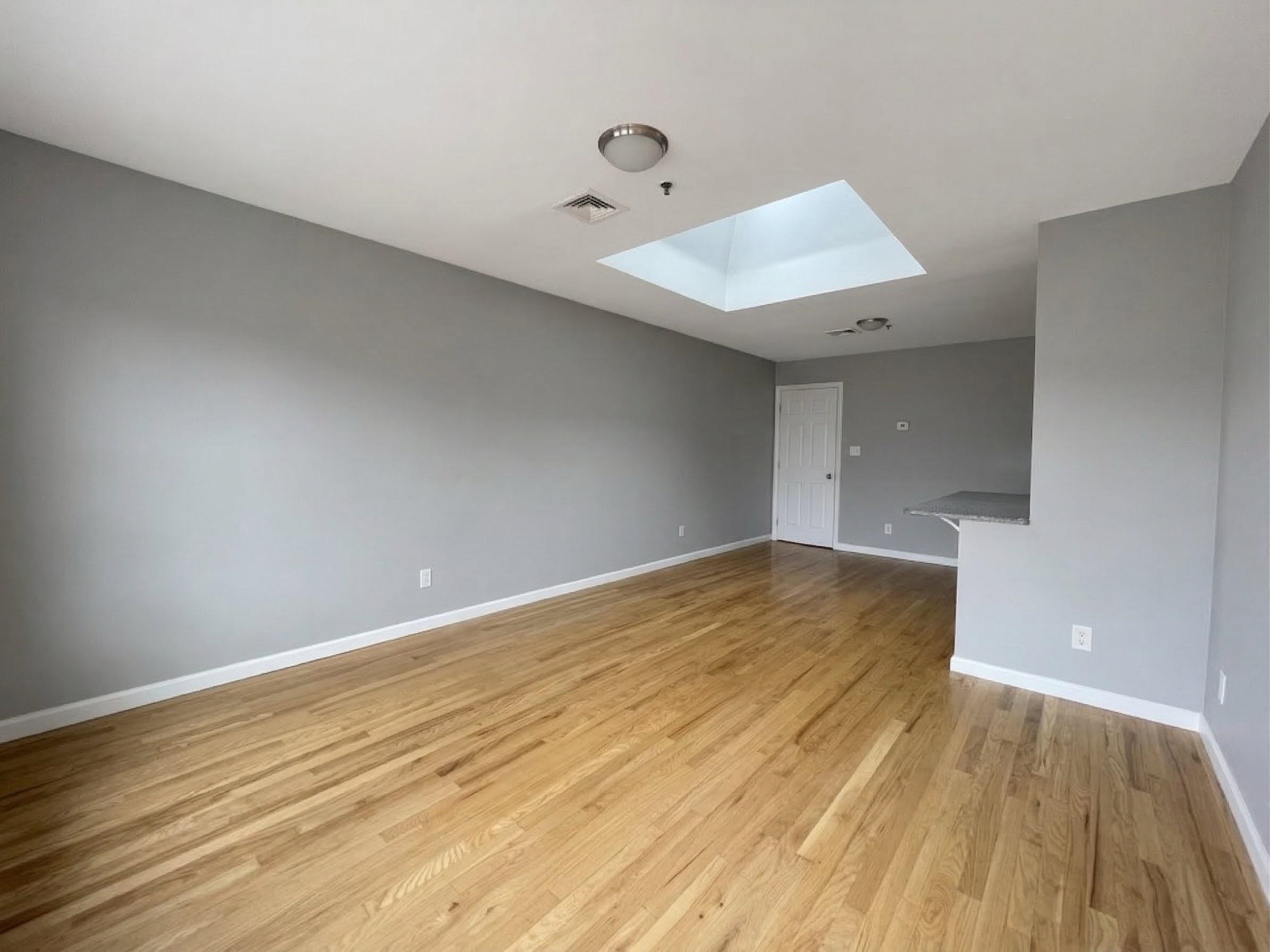 420 6th Street, Unit 3 Union City, NJ 07087 - Photo 3 of 12 a view of an empty room and wooden floor