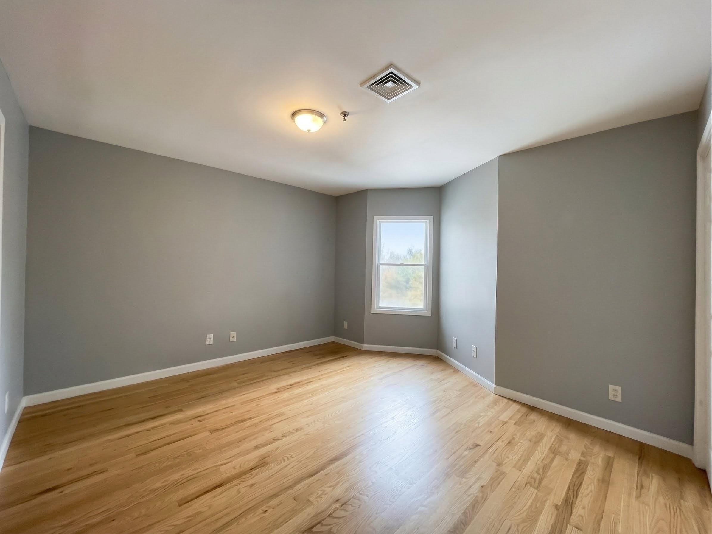 420 6th Street, Unit 3 Union City, NJ 07087 - Photo 6 of 12 a view of room with window and wooden floor