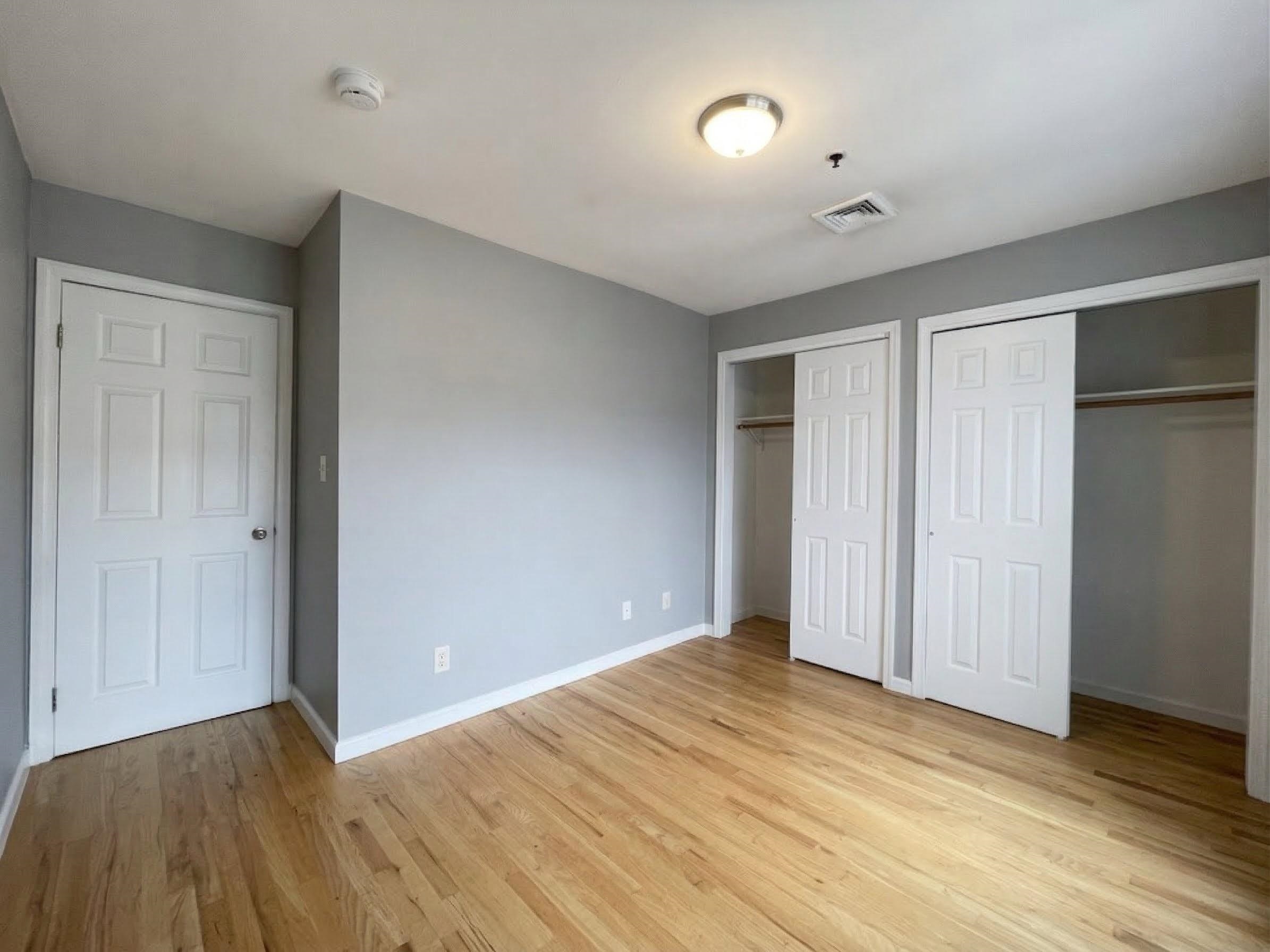 420 6th Street, Unit 3 Union City, NJ 07087 - Photo 9 of 12 a view of an empty room with wooden floor
