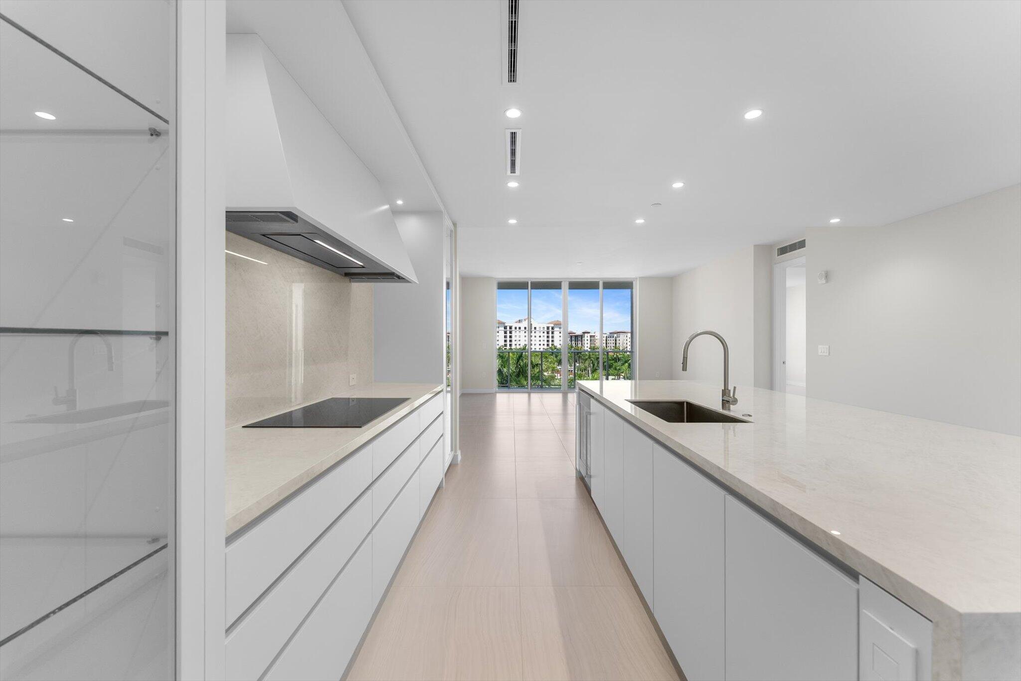 220 Southeast Mizner Boulevard, Unit 609 Boca Raton, FL 33432 - Photo 11 of 63 a large kitchen with a sink and cabinets