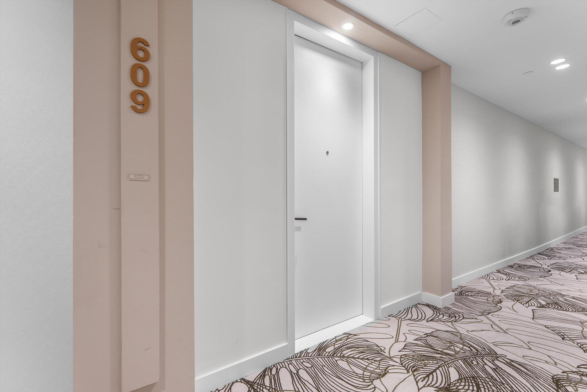 220 Southeast Mizner Boulevard, Unit 609 Boca Raton, FL 33432 - Photo 3 of 63 a view of a bedroom with wooden floor & bathroom