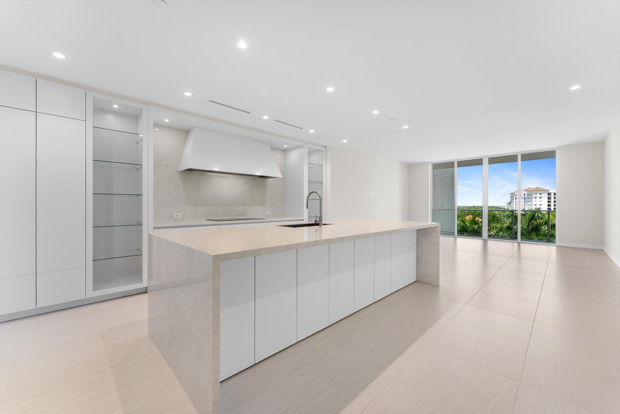 220 Southeast Mizner Boulevard, Unit 609 Boca Raton, FL 33432 - Photo 8 of 63 a view of a kitchen with kitchen island a sink stainless steel appliances and cabinets