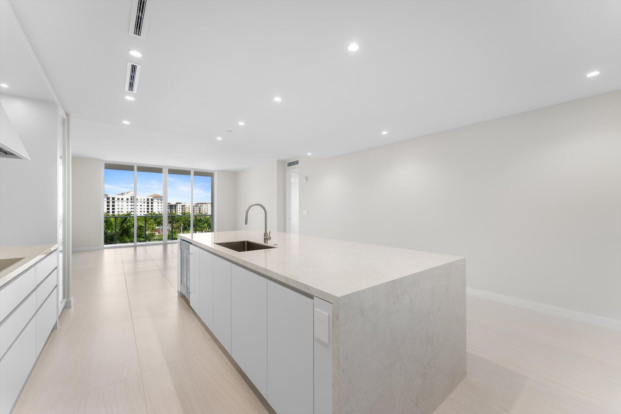 220 Southeast Mizner Boulevard, Unit 609 Boca Raton, FL 33432 - Photo 9 of 63 a large kitchen with a sink and cabinets