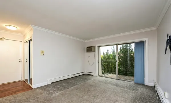a view of an empty room with glass door
