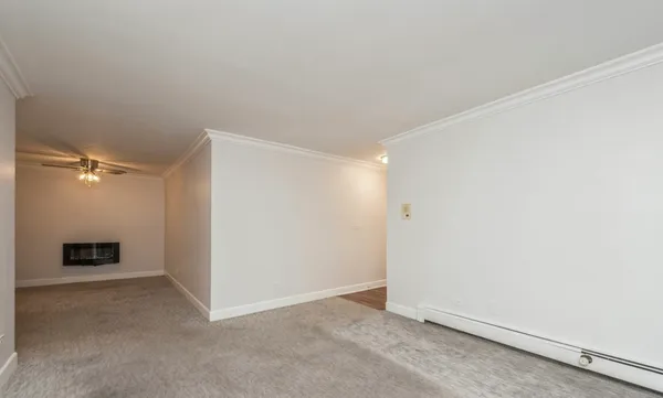 a view of an empty room with a fan