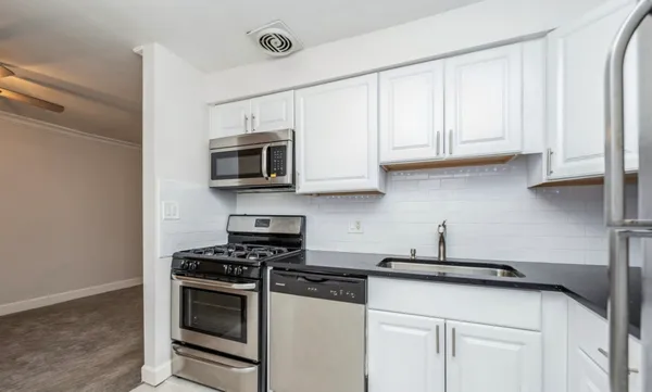 a kitchen with stainless steel appliances a refrigerator stove and microwave