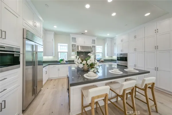a kitchen with stainless steel appliances granite countertop a stove and a refrigerator