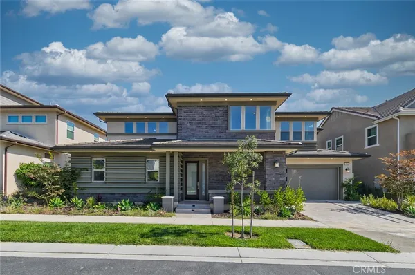 a front view of a house with a garden and entertaining space