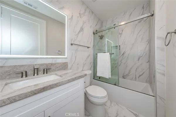 a bathroom with a toilet a sink and shower