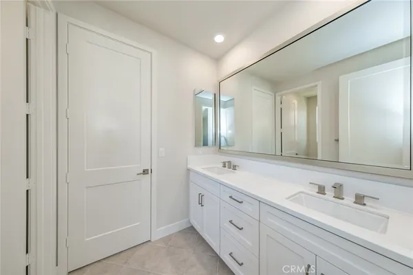 a bathroom with a toilet sink vanity and mirror